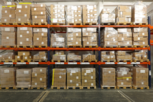 "Interior of GetTheTan's warehouse showcasing organized shelves of tanning products and packaging materials."